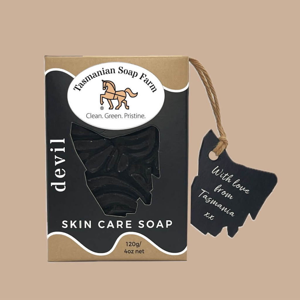 Tasmanian Soap Farm 'devil' skin care soap in a black and buff cardboard box with a hanging black tag, shown on a solid buff background.