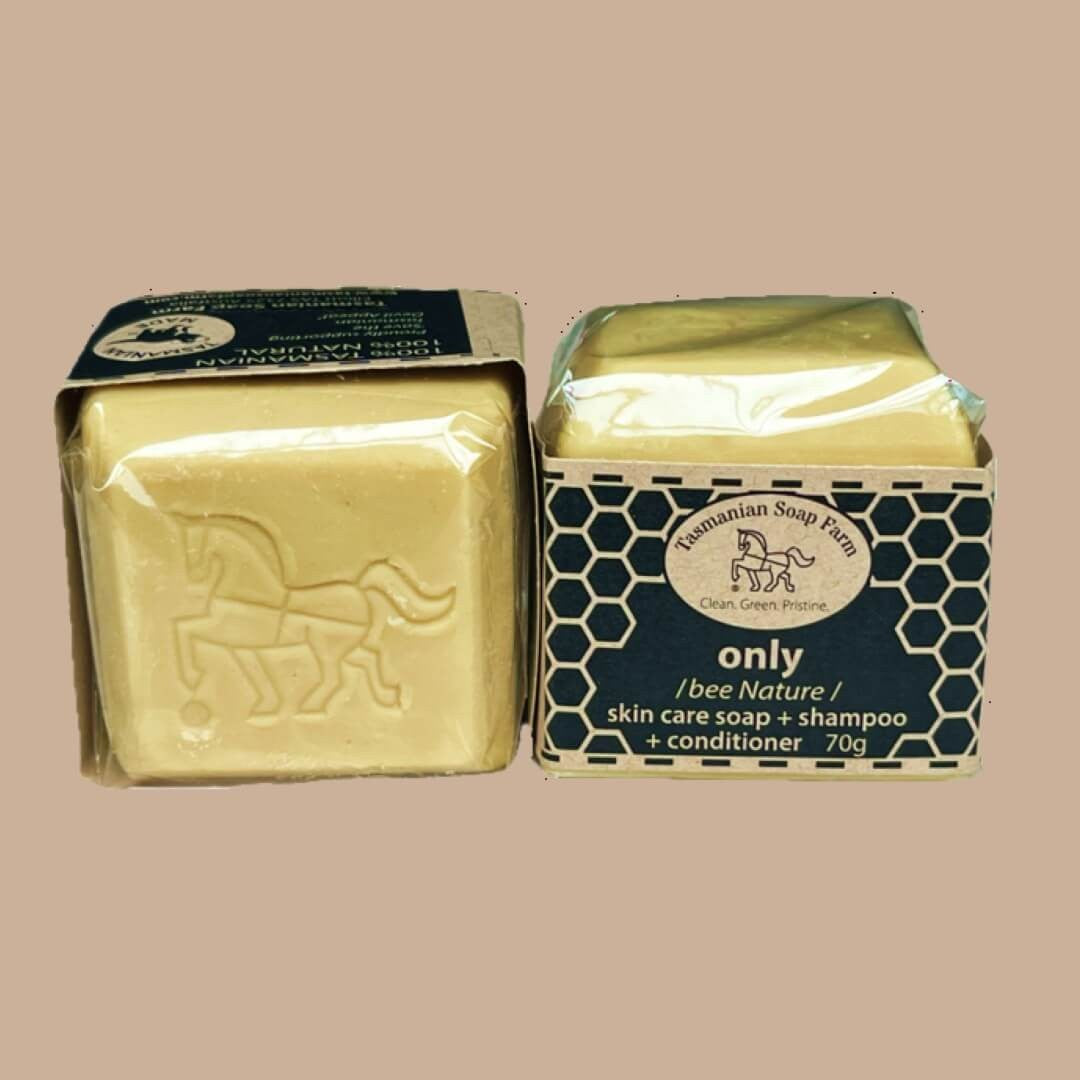 Two bars of Tasmanian Soap Farm 'only / bee Nature /' skin care and shampoo soap in one, shown in their packaging against a solid beige background.