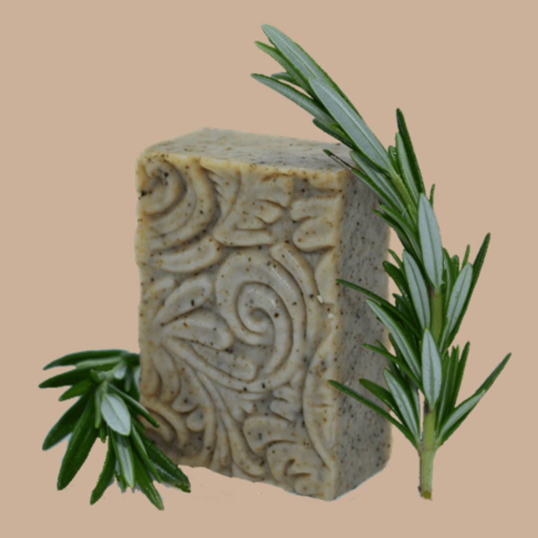 An embossed bar of Tasmanian Soap Farm handmade soap with rosemary sprigs on a solid beige background.