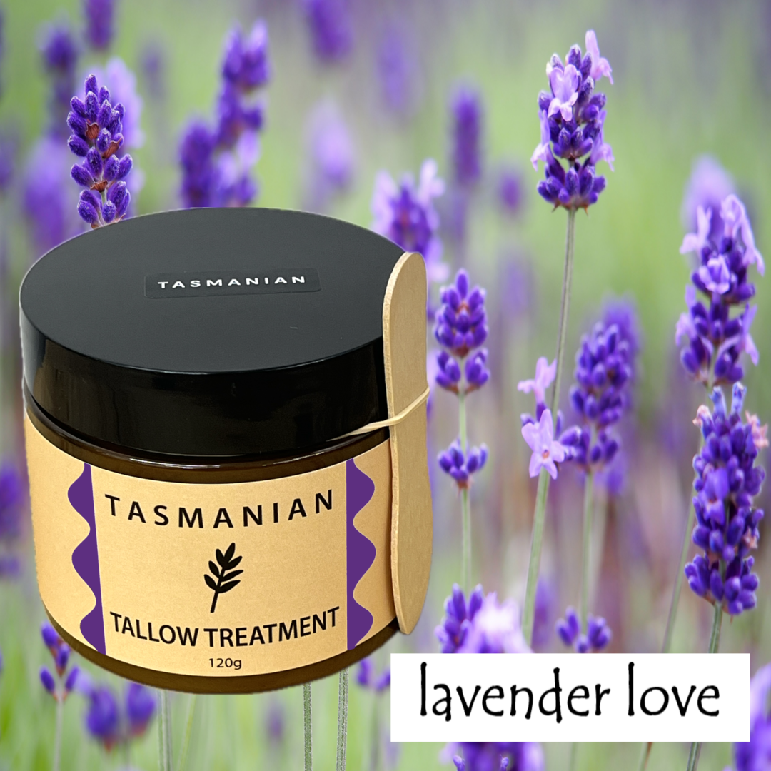 A jar of Tasmanian Tallow Treatment labelled 'lavender love' with a black lid and buff label, set against a blurred lavender field background.
